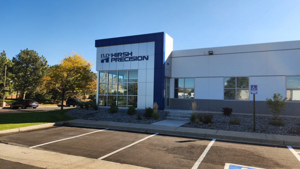 Hirsh Precision commercial building exterior with modern architecture, glass entrance, and landscaped surroundings