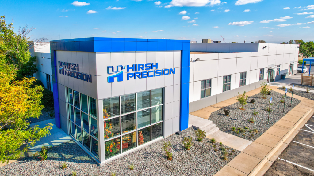 Modern industrial manufacturing facility exterior with blue and white building design