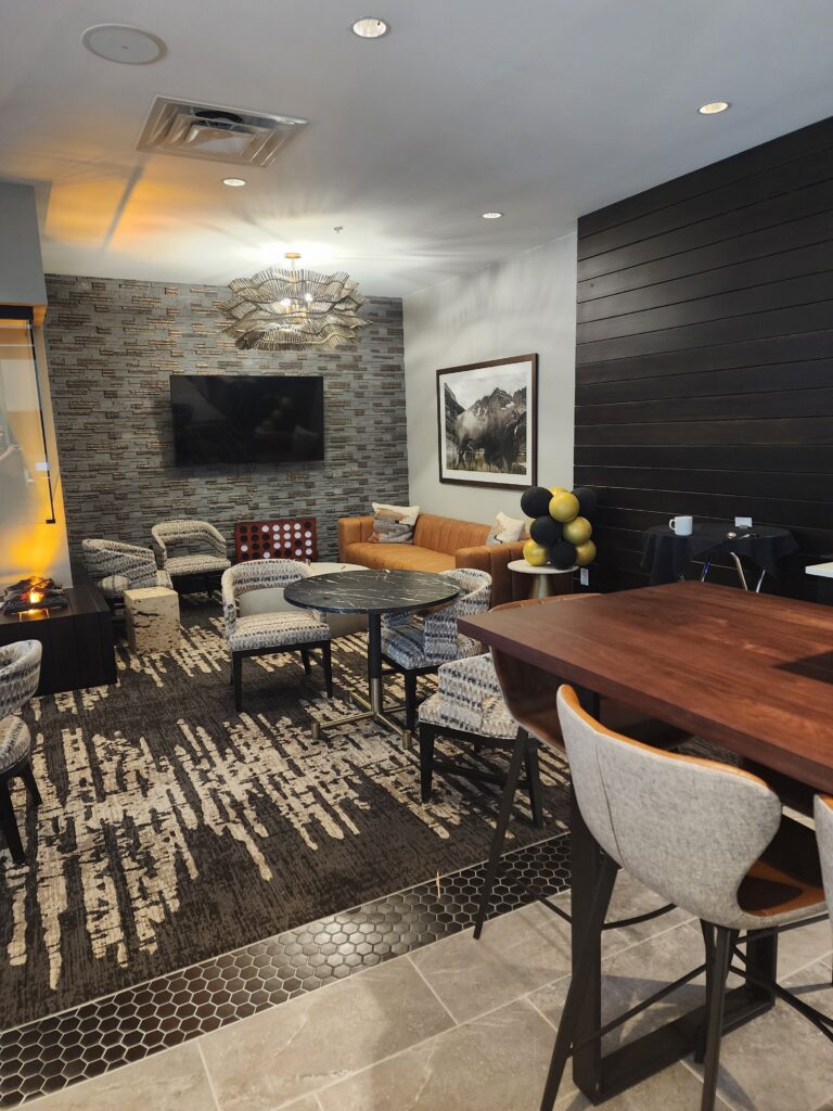 Modern office lounge area with stylish furniture, seating space, television wall, and contemporary interior design