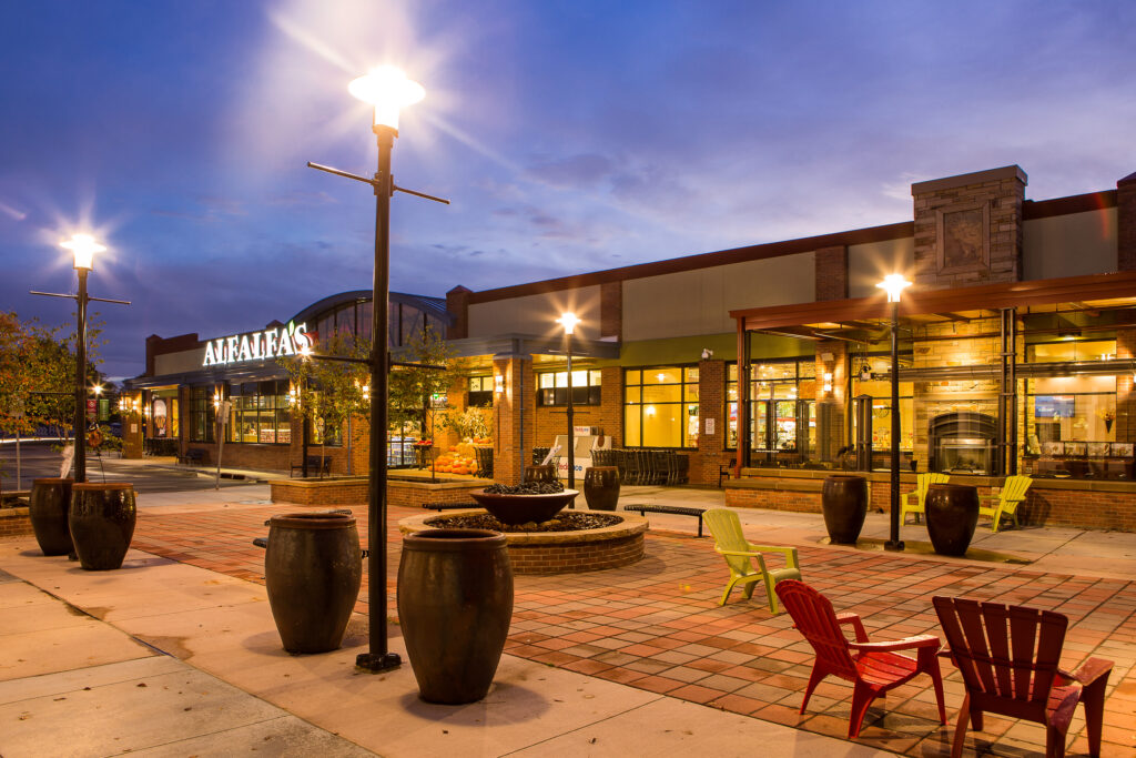 PEH Architects Alafias plaza exterior at evening with lighting, seating area, landscaping, and modern architecture