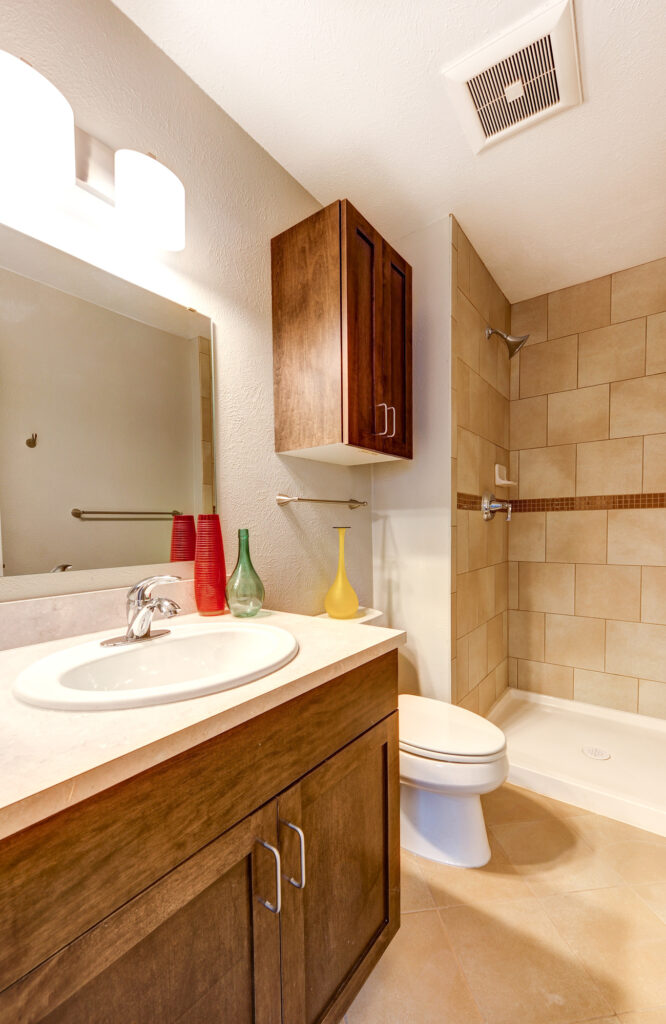 Contemporary bathroom interior with wooden vanity, tiled shower, sink, and modern home design
