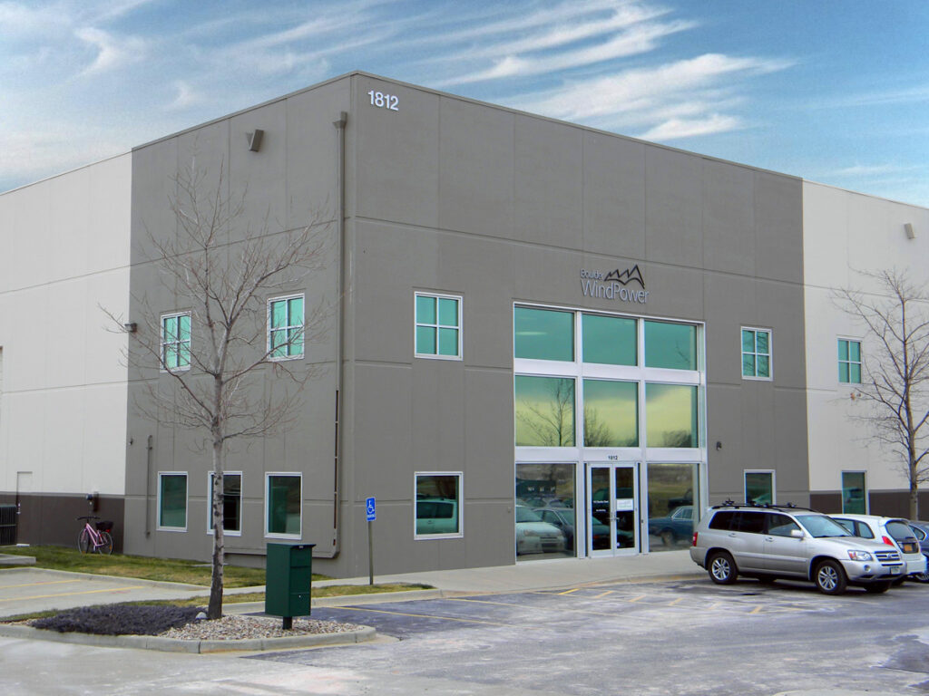 Modern commercial building exterior with clean architectural lines, glass entrance, and functional workspace design by PEH Architects