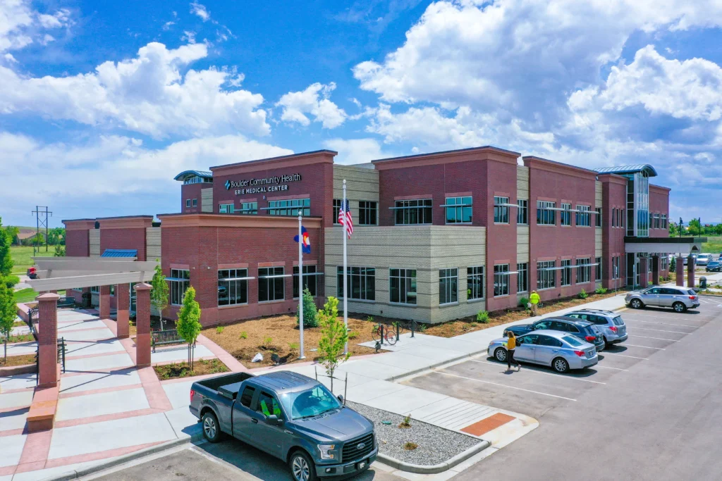 PEH Architects healthcare medical center exterior with modern brick architecture and parking area