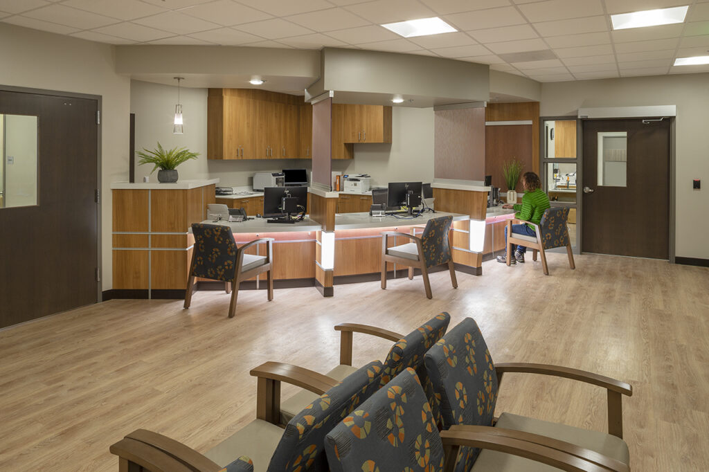Modern healthcare reception workspace with service counters, patient seating, and contemporary medical office interior design