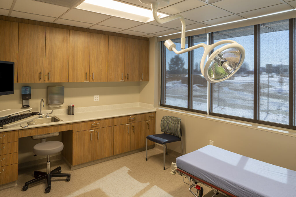 PEH Architects healthcare treatment room interior with medical examination bed and clinical workspace