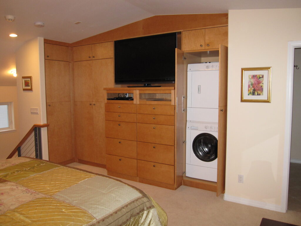 PEH Architects custom bedroom interior with built-in cabinets and TV storage
