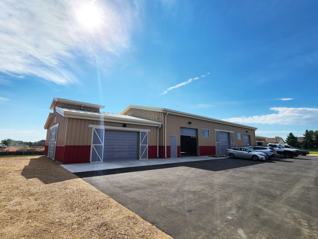 Modern agricultural building with large storage doors, functional workspace, and contemporary barn-style architecture by PEH Architects