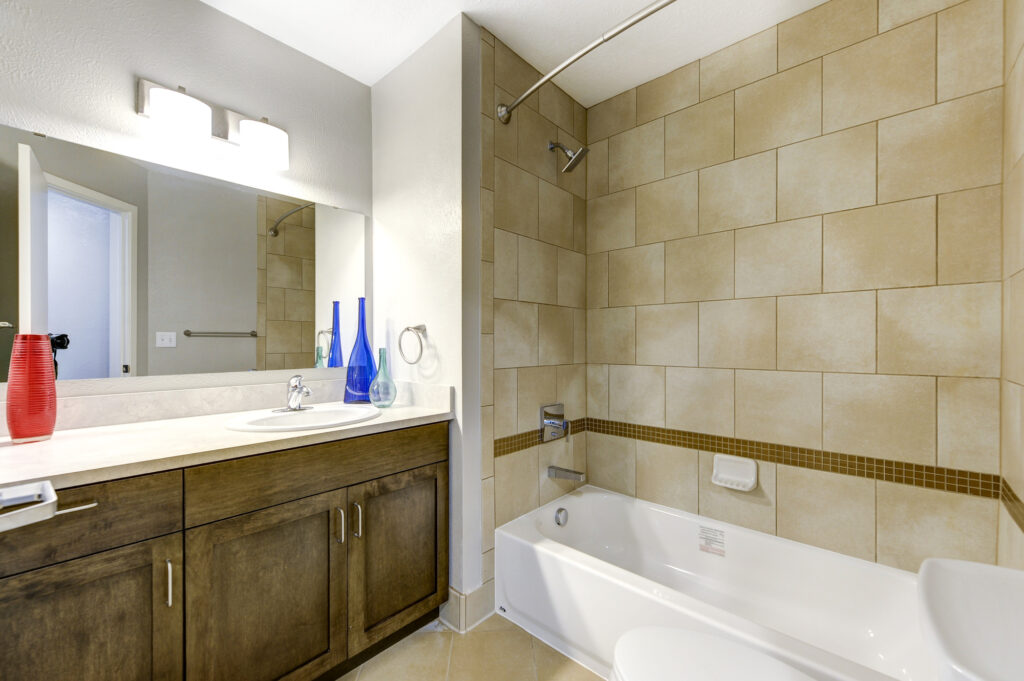 Modern bathroom with tiled shower, bathtub, wooden vanity, and mirror interior design