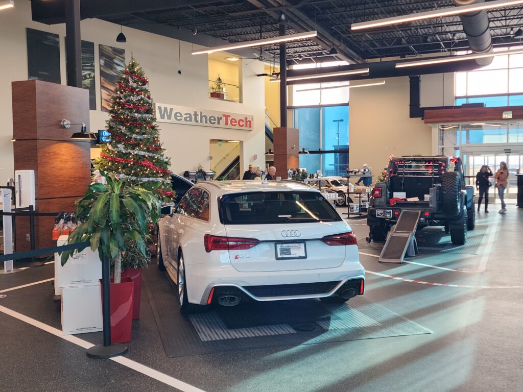Modern car showroom interior featuring luxury vehicles, display areas, and contemporary commercial architecture