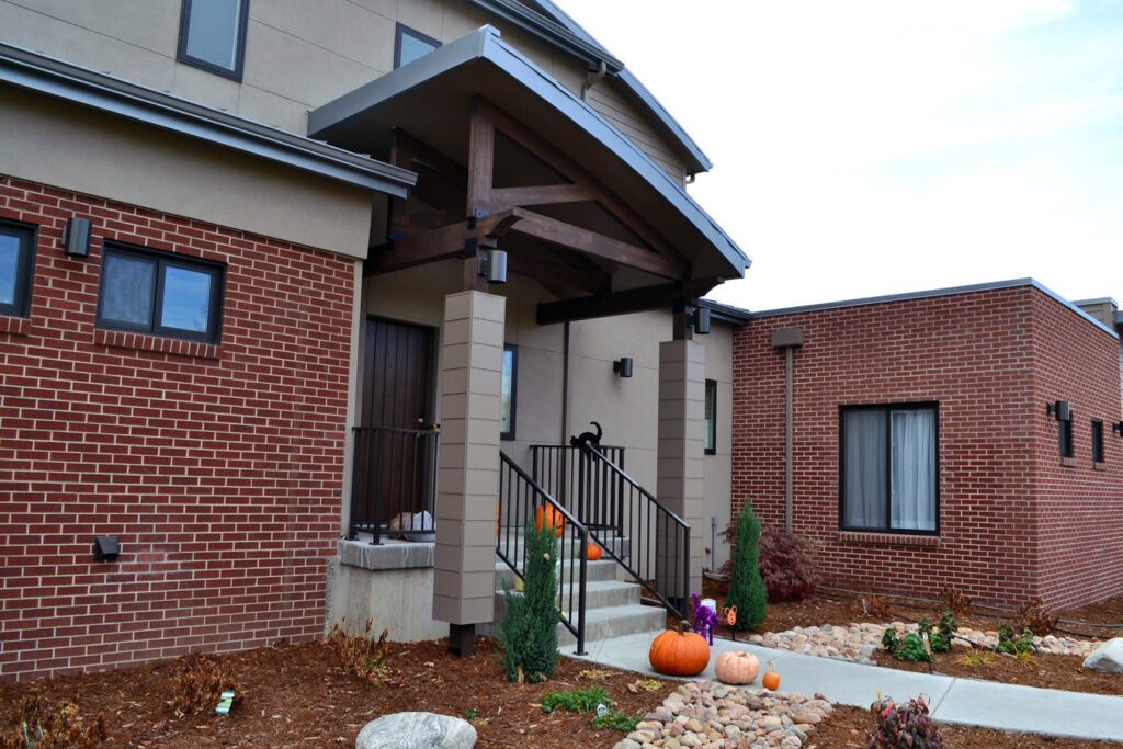 PEH Architects modern home front entrance with timber porch and brick exterior design