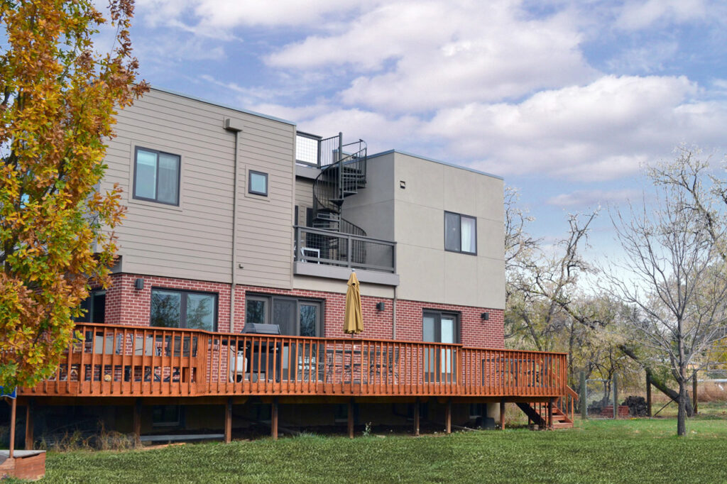PEH Architects contemporary home rear exterior with brick walls and wooden deck design