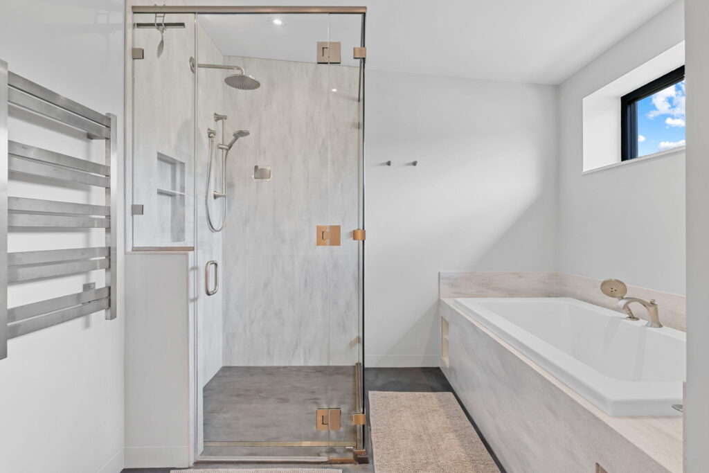 PEH Architects modern bathroom interior with glass shower enclosure and bathtub design