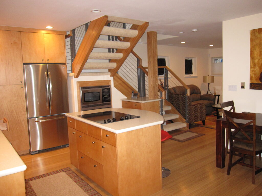 PEH Architects open concept kitchen interior with custom cabinets and living area