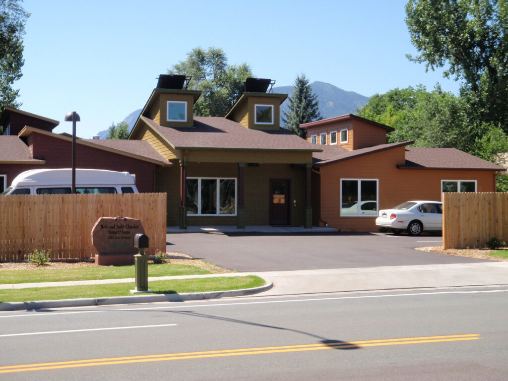 Modern smart home exterior featuring residential architecture, landscaped surroundings, and mountain views