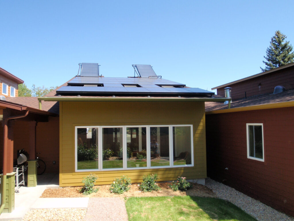 Solar-powered smart home exterior featuring rooftop panels, modern residential design, and sustainable architecture
