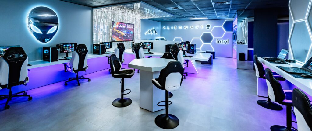 Large Alienware esports gaming lounge with RGB lighting, gaming PCs, esports chairs, and futuristic interior design