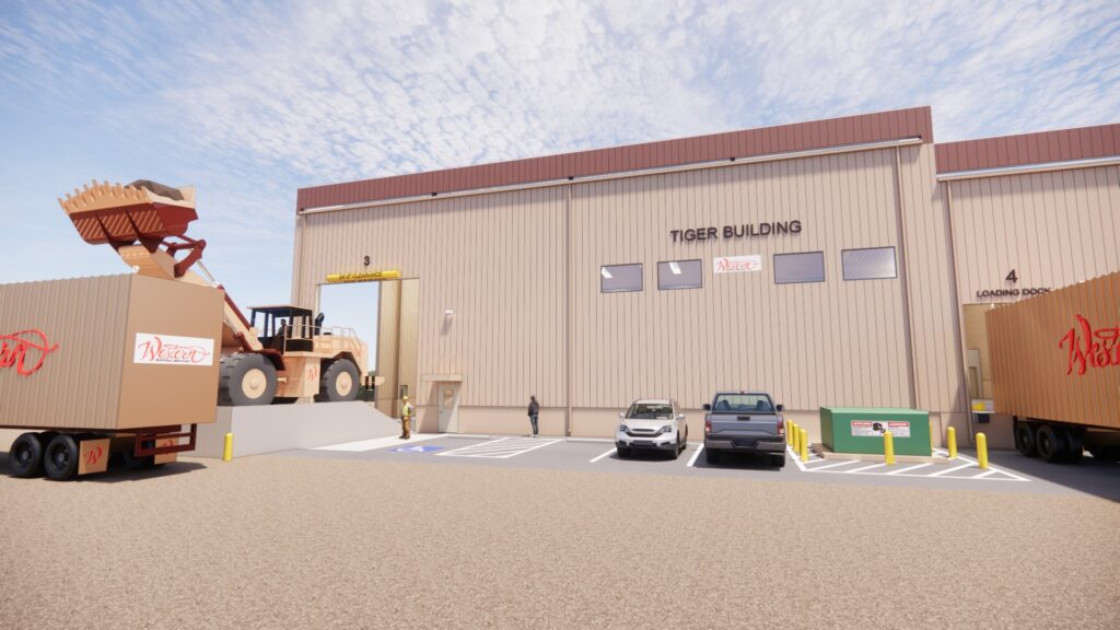 Industrial warehouse building with loading docks, delivery trucks, construction equipment, and commercial facility design
