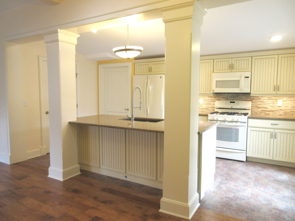 Open concept kitchen remodel featuring custom cabinets, granite countertops, kitchen island, and modern lighting