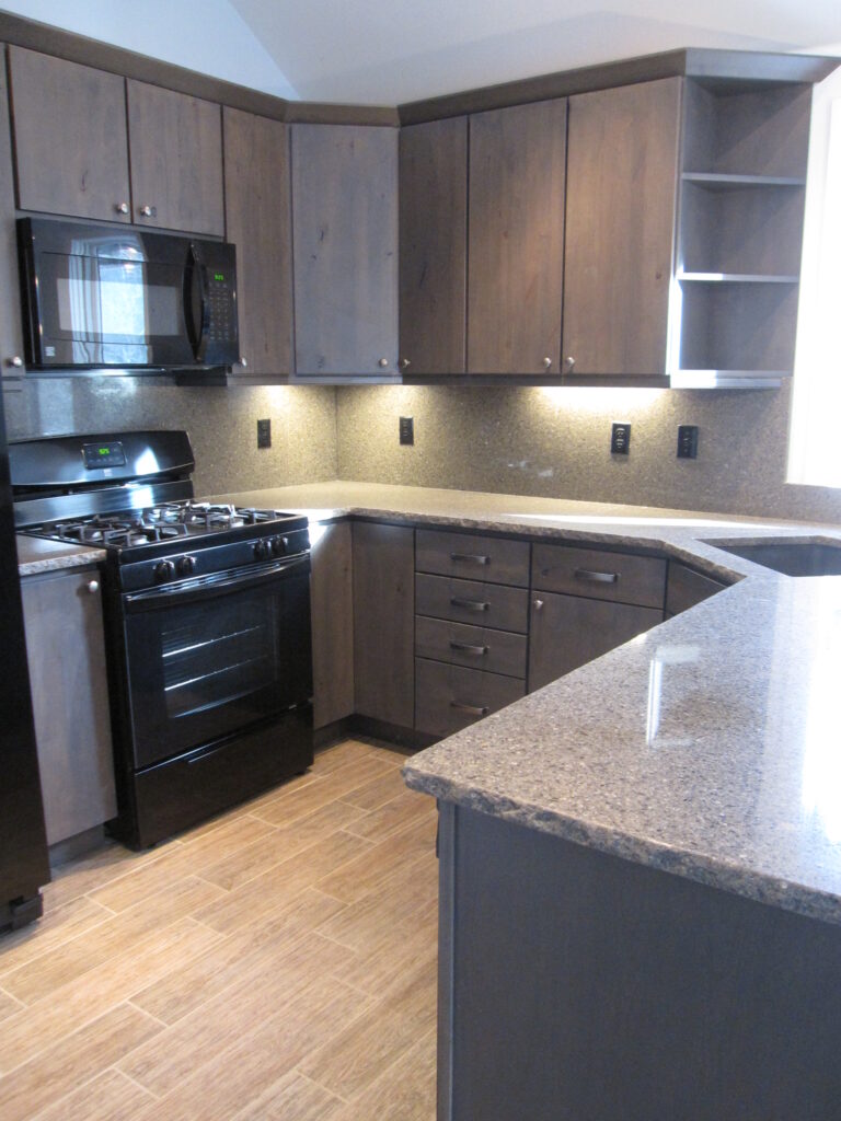 Modern kitchen renovation featuring custom gray cabinets, granite countertops, stainless steel appliances, and contemporary design by PEH Architects in Boulder